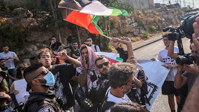 Israeli police confiscate a flag from a protester during a demonstration by Palestinian, Israeli and foreign activists against Israeli occupation and settlement activity, in Sheikh Jarrah in East Jerusalem on July 30, 2021. AFP
