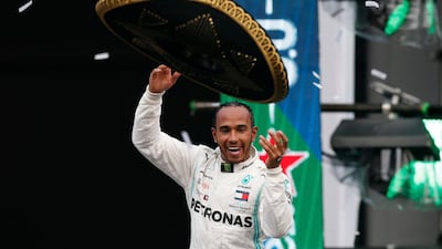 Mercedes driver Lewis Hamilton throws a Mexican Charro hat to the crowd as he celebrates his victory at the Mexico Grand Prix. AP Photo