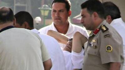 Egyptian soldiers and medics escort former president Hosni Mubarak to a military hospital in the upscale southern Cairo suburb of Maadi.