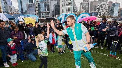 Aaron Finch of Australia high fives a young fan during the T20 World Cup Trophy Tour Launch at Crown Riverwalk on July 08, 2022 in Melbourne, Australia. Getty Images