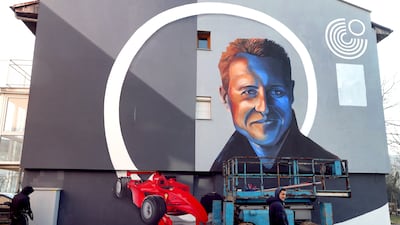 Bosnian artists work on a mural depicting former seven-time Formula One champion Michael Schumacher in Dobrinja, a suburb of Sarajevo, Bosnia and Herzegovina, 04 January 2022. The artwork is painted on a side of a building that was partially rebuilt by donations raised by Schumacher after the war in Bosnia. EPA / FEHIM DEMIR