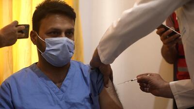 A Syrian nurse receives the AstraZeneca Covid-19 vaccine at Ibn Sina Hospital in Idlib, north-western Syria. AP