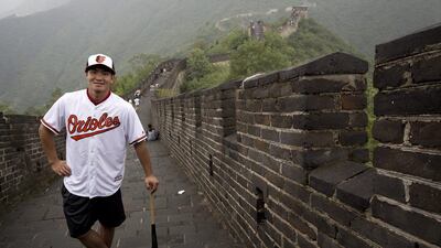 New Baltimore Orioles signing Xu Guiyan poses at the Mutianyu section of the Great Wall of China in Beijing on Thursday. Andy Wong / AP / July 23, 2015