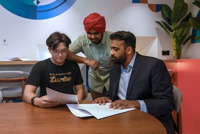 From left, AI students Nurtore Arynuruly and Harmanjot Singh, with Farzan Ahmad Khan. Victor Besa / The National