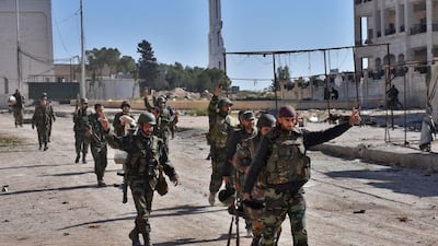 Syrian pro-government soldiers walk down a road in the ‘3000’ apartment block area in Al Hamdaniyah district of Aleppo on November 4, 2016. George Ourfalian / AFP