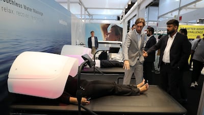 Visitors look at a water massage bed