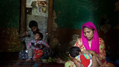 Nazia and her husband, leper patient Noor-u-Din feed their children.