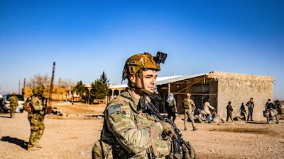 US soldiers patrol the front line between areas held by the Syrian Democratic Forces and Turkey-backed fighters near the village of Dardara in Syria's north-east Hasakeh province on December 26, 2021. AFP
