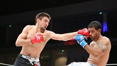 Jason Santana, of the US, in white shorts, fights with Pavel Gordeev from Russia in the Abu Dhabi Warriors 4 at IPIC Arena in Zayed Sports city in Abu Dhabi. Ravindranath K / The National