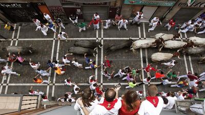 Bulls from the ranch Jose Escolar Gil run past revelers through the Estafeta Street during the third bull run of the Festival of San Fermin 2016 in Pamplona, Spain. Jesus Diges / EPA