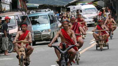 Filipino Ifugao tribesmen ride on wooden scooters during the Imbayah Festival, a gathering of tribesmen to preserve their culture and tradition, at a village in the upland town of Banaue, Ifugao province, Philippines. The wooden scooter has long been the preferred transportation for the Ifugao tribesmen, a cheaper alternative to gas-powered motorcycles as they use to tend to their rice crops in the Unesco World Heritage site Banaue Rice terraces. Harley Palangchao / EPA