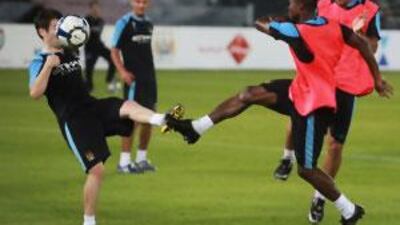 The Manchester City players train at the Zayed Sports City before their match today.