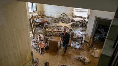 A resident inspects flood damage to his home after torrential rain caused flash floods and landslides in Yongchuan district, Chongqing, China. Reuters