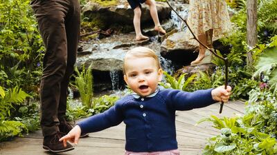 Public first steps! Prince Louis can be seen running away from his father, Prince William, in one of the cute family photos. Matt Porteous / Kensington Palace via Getty Images