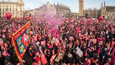 Striking mail workers and supporters gather in Parliament Square to listen to speeches by union leaders and representatives on Friday in London. Getty