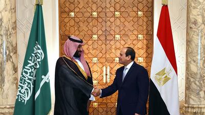 In this photo released by the Egyptian Presidency's office, Saudi Arabia's Crown Prince Mohammed bin Salman shakes hands with Egyptian President Abdel-Fattah El-Sissi in Cairo on Tuesday, Nov. 27, 2018. (Egyptian Presidency via AP)