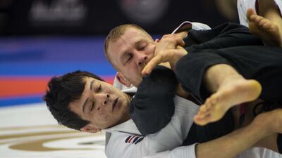 Paulo Miyao, in white, on his way to winning two golds in London. Courtesy UAEJJF