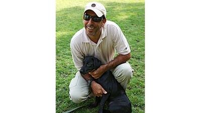 Lt Col Khalid al Merri, the founder and head of the RAK Police dog unit, with one of the latest recruits. The new dog is an descendant of Dinah.