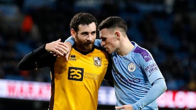 Port Vale's David Worrall (left) and Manchester City's Phil Foden during the FA Cup third round match at the Etihad Stadium, Manchester. PA Photo.