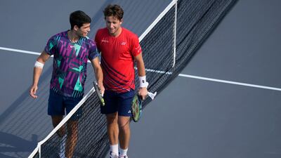 Carlos Alcaraz and by Casper Ruud at the net after the end of their match. AP
