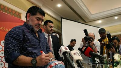 Diego Maradona a football as he was officially introduced to the media as the club's new manager at a press conference in Fujairah on Sunday, May 14, 2017. Satish Kumar / The National