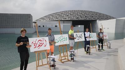 From left: Andrey Rublev, Dominic Thiem, Kevin Anderson, Pablo Carreno Busta and Roberto Bautista Agut try their hand at writing their names in Arabic calligraphy at the Louvre Abu Dhabi on Saadiyat Island. Rublev faces Bautista Agut in his opening match of the Mubadala World Tennis Championship at the International Tennis Stadium in Abu Dhabi on Thursday. Courtesy IPN