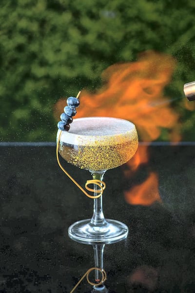 A drink - in a a gold-flaked glass, of course - gets the culinary torch treatment at Aer