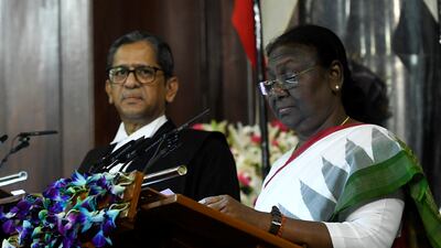 The new president takes the oath of office as Chief Justice NV Ramana looks on. AP