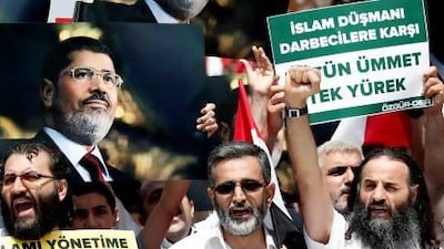 Protestors hold pictures of the ousted Egyptian president Mohammed Morsi at a rally in Istanbul on Saturday. Sedat Suna / EPA