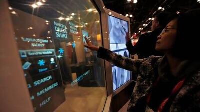The National Retail Federation conference in New York showcased cutting-edge technology, such as deal-sending screens, top, that can help retailers know their customers' habits and preferences better, and cash in on the online boom. Emmanuel Dunand / AFP
