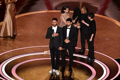 Basel Adra, wearing white Resolute RGL shoes, accepts his Oscar alongside Yuval Abraham. AFP
