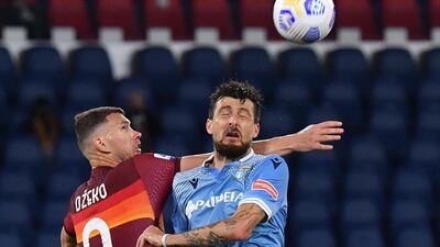 Roma's Bosnian forward Edin Dzeko and Lazio's Italian defender Francesco Acerbi go for a header. AFP