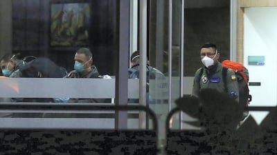 A member of the Colombian air force is seen at the entrance of a sports village, where Colombians who return from China will be isolated, in Bogota, Colombia. REUTERS