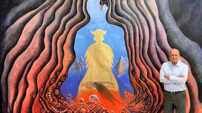 Iraqi artist Ala Bashir standing next to one of his paintings. Courtesy Ala Bashir