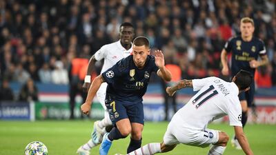 Real Madrid's Belgian forward Eden Hazardfights for the ball with Paris Saint-Germain's Argentine midfielder Angel Di Maria. AFP