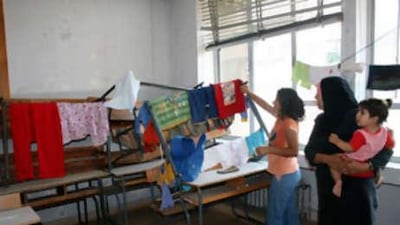 Lebanese Sunni residents of Tripoli's Bab al-Tebbaneh neighbourhood take refuge inside a school as they flee the area of clashes yesterday.