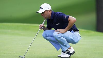 Justin Thomas of the US lines up his putt on the seventh hole. The American sits at five under but will have to complete his first round on Friday. EPA