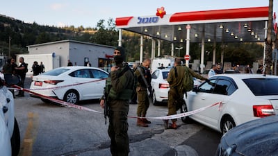 Security personnel work at the scene of the shooting near the Israeli settlement of Eli in the occupied West Bank. Reuters