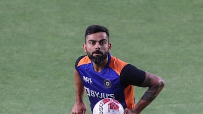 India captain Virat Kohli tests out his football skills during a warm-up session ahead of the first T20 match against England that takes place on March 12, at the Narendra Modi Stadium in Ahmedabad. PA