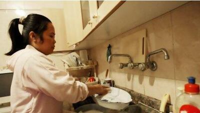 A house maid from the Philippines washes the dishes at her employers' apartment in Beirut. Lebanon’s large domestic worker community is beginning to fight abuse by taking employers to court.