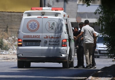 Palestinians carry a wounded person to an ambulance after he was injured during an Israeli army operation in Nablus. EPA