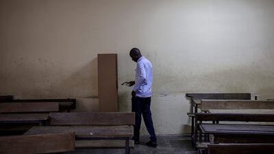 A voter in Yopougon, Abidjan, walks to the voting booth to mark his ballot at Segbe school polling station on October 25 as the polls open during Ivory Coast's presidential elections. AFP
