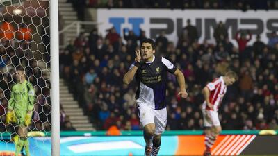Luis Suarez added two more goals to his Premier League-leading total on Sunday. Jon Super / AP
