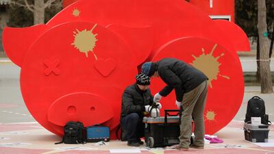 Workers make tea near decorations ahead of the Chinese Lunar New Year at Ditan Park in Beijing. AP Photo