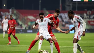 Saeid Ezatolahi of Shabab Al Ahli battles with Felício Milson of Al Jazira.