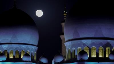 The pink supermoon rises over the Sheikh Zayed Grand Mosque in Abu Dhabi, in April 2020. Victor Besa / The National