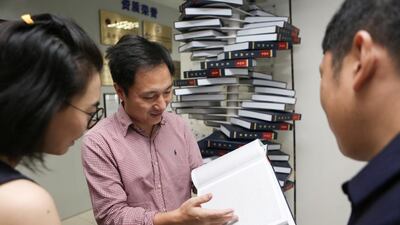 Scientist He Jiankui shows 'The Human Genome', a book he edited, at his company Direct Genomics in Shenzhen, Guangdong province, China August 4, 2016. Reuters