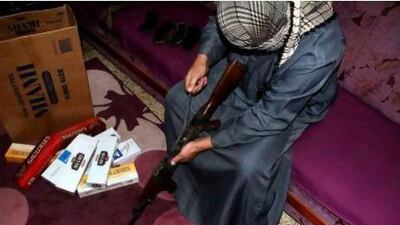 Younis Al Lehaibi, an Iraqi gun smuggler, dismantles a Kalashnikov at his house in Mosul, 360 kilometres north-west of Baghdad. To successfully smuggle into Syria, the rifles are taken apart and hidden in cigarette cartons and kerosene tanks.