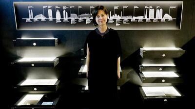 Michele Bambling, the curator os the UAE's National Pavilion, poses amid the drawers containing the exhibition 'Lest We Forget: Structures of Memory in the United Arab Emirates. Domenico Stinellis / AP Photo