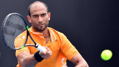 Egypt's Mohamed Safwat hits a return against France's Gregoire Barrere during their men's singles match on day one of the Australian Open in Melbourne on January 20. AFP
